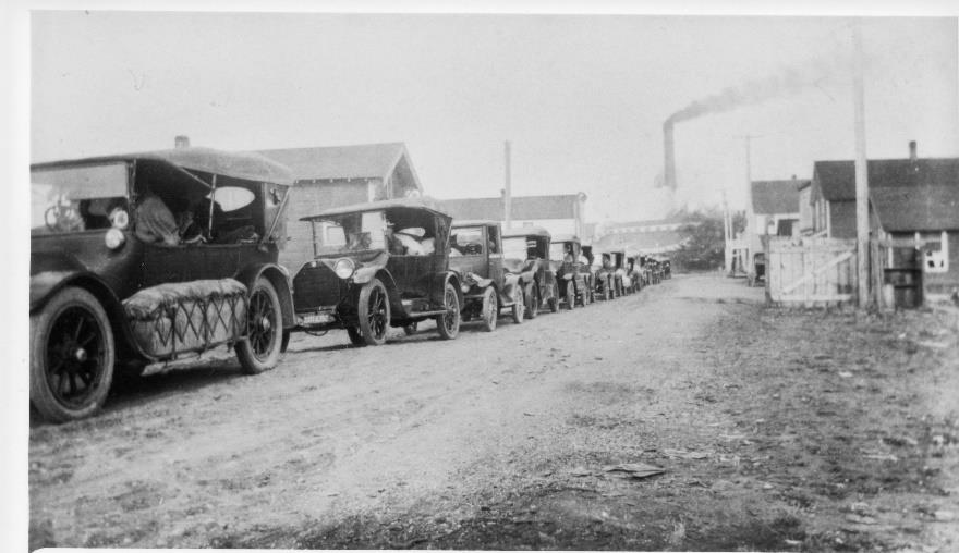Cars waiting in line at ferry dock 1920s
