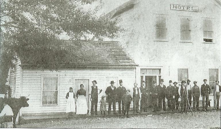 Individuals posing outside of Fowler house, site of Snohomish's 1st post office